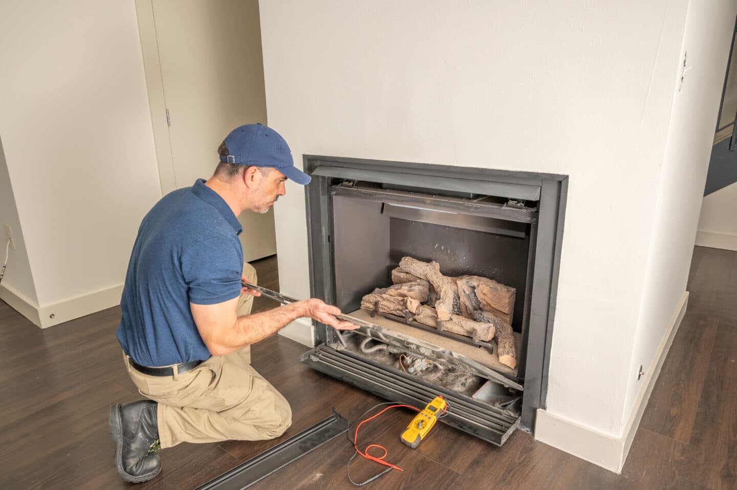 man taking apart a fireplace for inspection